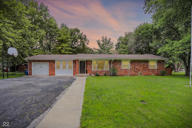 4132 Tincher Rd, Indianapolis, IN 46221 - view of front of house featuring an attached garage, driveway, a front lawn, and brick siding