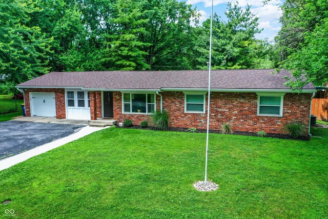 4132 Tincher Rd, Indianapolis, IN 46221 - ranch-style home featuring an attached garage, brick siding, driveway, and roof with shingles