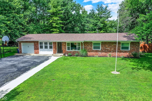 4132 Tincher Rd, Indianapolis, IN 46221 - single story home with an attached garage, brick siding, asphalt driveway, and roof with shingles