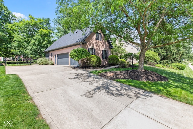 11266 Old Stone Dr, Indianapolis, IN 46236 - view of side of home featuring concrete driveway, a garage, and a shingled roof