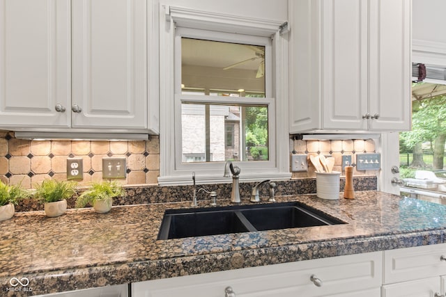 11266 Old Stone Dr, Indianapolis, IN 46236 - kitchen with dark countertops, white cabinetry, and tasteful backsplash