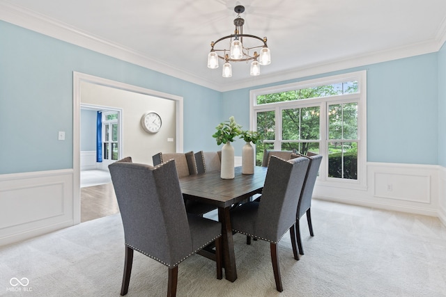 11266 Old Stone Dr, Indianapolis, IN 46236 - dining room with a chandelier, a wainscoted wall, crown molding, light carpet, and a decorative wall