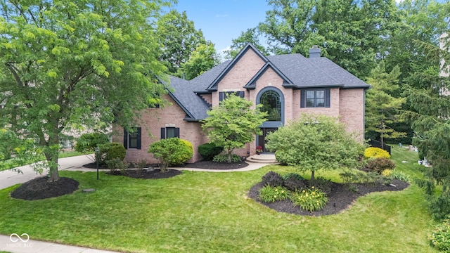 11266 Old Stone Dr, Indianapolis, IN 46236 - view of front of house featuring brick siding, roof with shingles, a chimney, and a front lawn