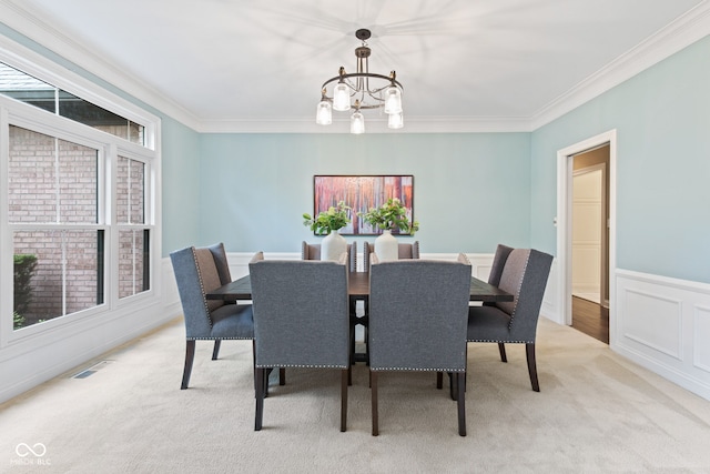11266 Old Stone Dr, Indianapolis, IN 46236 - dining area with a chandelier, light carpet, ornamental molding, and a wainscoted wall