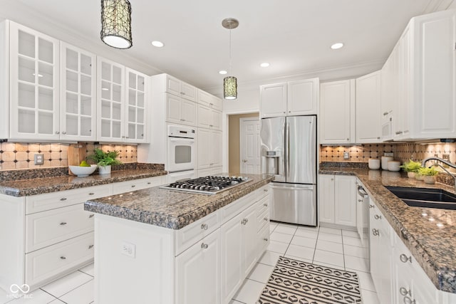 11266 Old Stone Dr, Indianapolis, IN 46236 - kitchen with stainless steel appliances, a kitchen island, light tile patterned flooring, backsplash, and white cabinetry