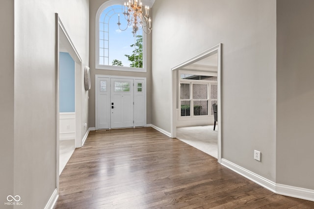 11266 Old Stone Dr, Indianapolis, IN 46236 - foyer with a chandelier, a towering ceiling, and wood finished floors