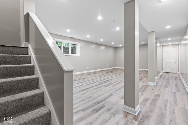 11266 Old Stone Dr, Indianapolis, IN 46236 - below grade area featuring light wood-style flooring, stairs, and recessed lighting