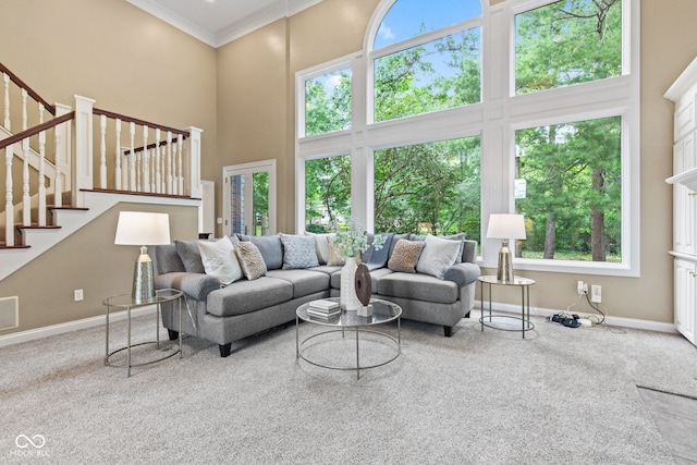 11266 Old Stone Dr, Indianapolis, IN 46236 - carpeted living area with a towering ceiling, stairs, and crown molding