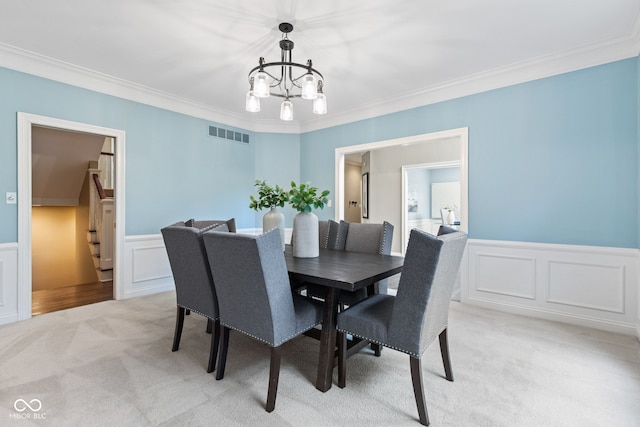 11266 Old Stone Dr, Indianapolis, IN 46236 - dining area with light colored carpet, a chandelier, crown molding, wainscoting, and a decorative wall