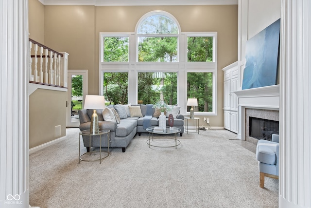 11266 Old Stone Dr, Indianapolis, IN 46236 - living area featuring a high ceiling, carpet, a fireplace, and stairs