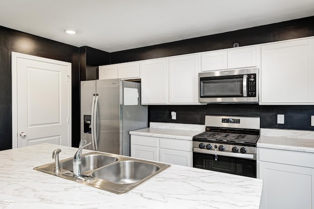 6332 Card Blvd, Indianapolis, IN 46221 - kitchen with appliances with stainless steel finishes, white cabinets, and backsplash