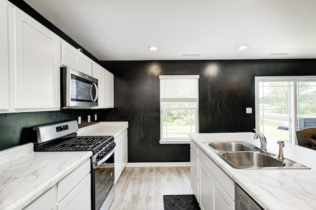 6332 Card Blvd, Indianapolis, IN 46221 - kitchen featuring appliances with stainless steel finishes, light wood finished floors, white cabinetry, and recessed lighting