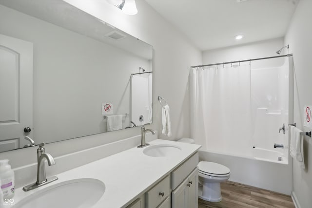 633 Cowley Dr, Westfield, IN 46074 - bathroom featuring double vanity, wood finished floors, and shower / bath combo