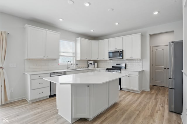 633 Cowley Dr, Westfield, IN 46074 - kitchen with appliances with stainless steel finishes, white cabinets, light countertops, decorative backsplash, and recessed lighting