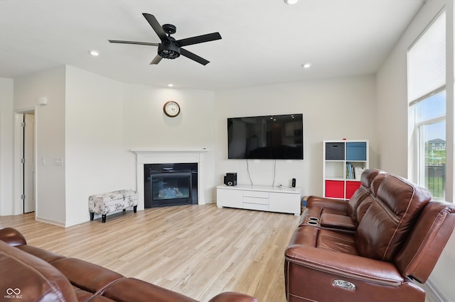 633 Cowley Dr, Westfield, IN 46074 - living area featuring light wood-style floors, a ceiling fan, a glass covered fireplace, and recessed lighting