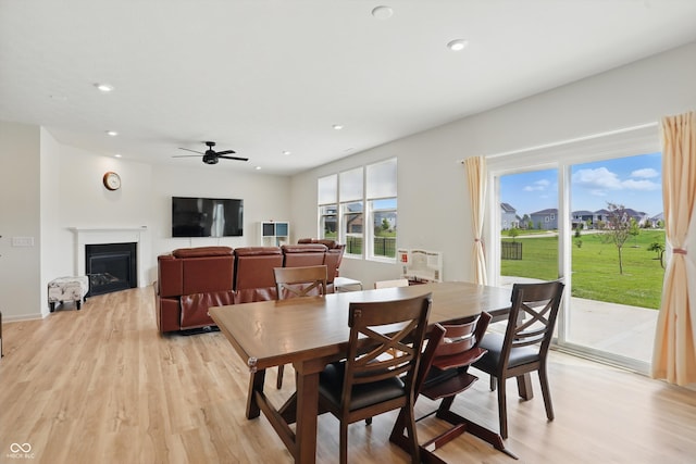 633 Cowley Dr, Westfield, IN 46074 - dining space featuring plenty of natural light, light wood finished floors, a glass covered fireplace, ceiling fan, and recessed lighting