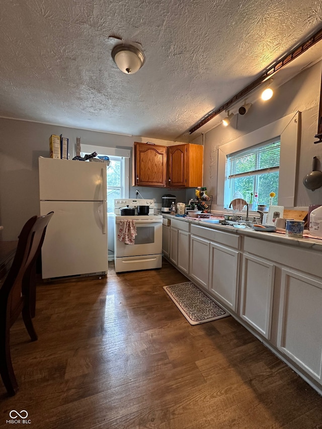 1728 N Somerset Ave, Indianapolis, IN 46222 - kitchen with white appliances, healthy amount of natural light, dark wood-style floors, a textured ceiling, and brown cabinets