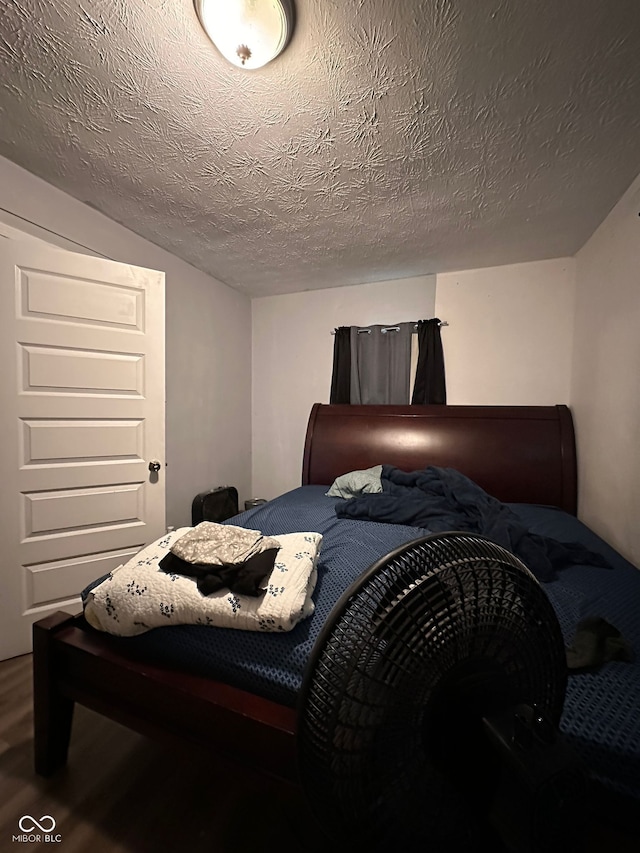 1728 N Somerset Ave, Indianapolis, IN 46222 - bedroom featuring wood finished floors and a textured ceiling