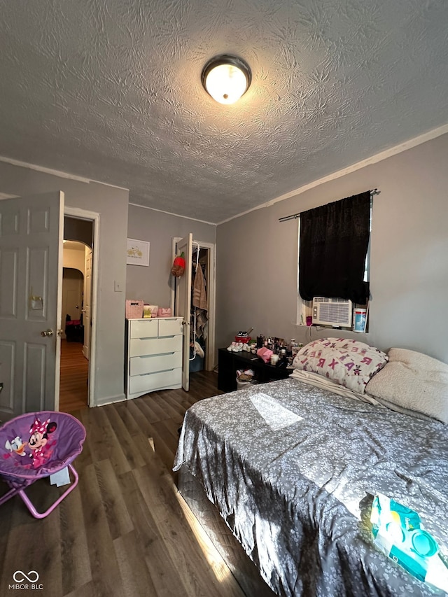 1728 N Somerset Ave, Indianapolis, IN 46222 - bedroom featuring a textured ceiling, a closet, wood finished floors, a spacious closet, and cooling unit