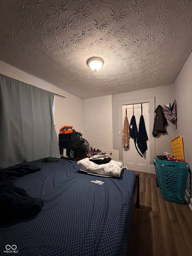 1728 N Somerset Ave, Indianapolis, IN 46222 - bedroom with wood finished floors and a textured ceiling