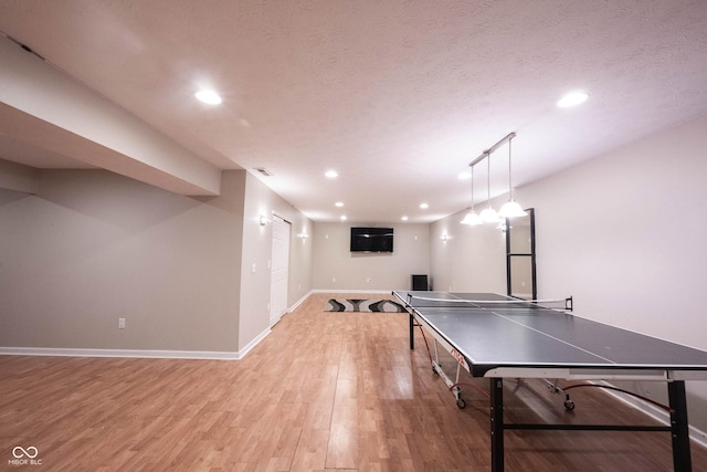 13829 Black Canyon Ct, Fishers, IN 46038 - rec room with light wood-type flooring, recessed lighting, and a textured ceiling