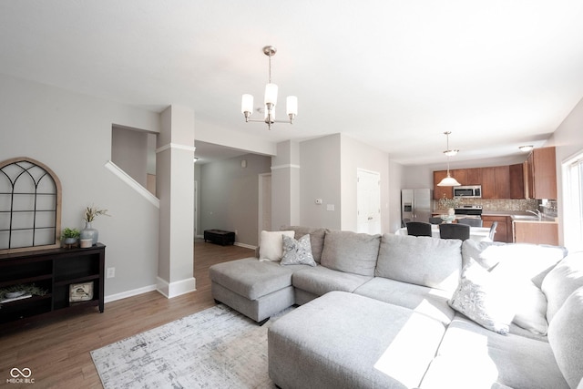 13829 Black Canyon Ct, Fishers, IN 46038 - living room with light wood-style flooring and a chandelier