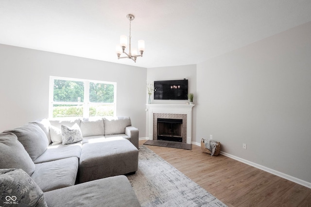 13829 Black Canyon Ct, Fishers, IN 46038 - living area with a chandelier, light wood-type flooring, and a fireplace