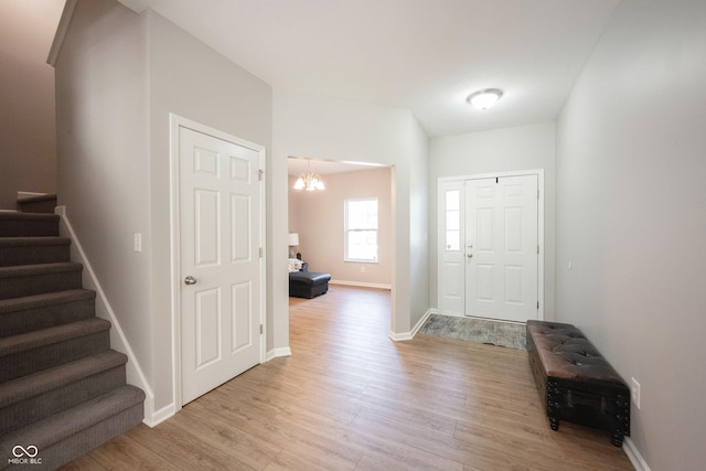 13829 Black Canyon Ct, Fishers, IN 46038 - foyer featuring a chandelier, stairs, and light wood-type flooring
