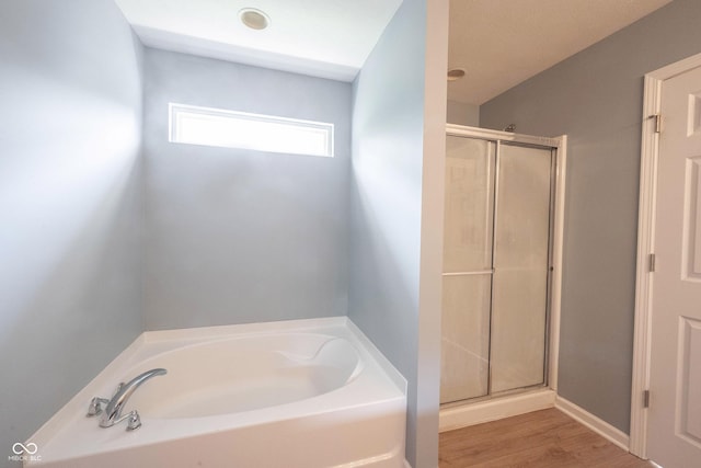 13829 Black Canyon Ct, Fishers, IN 46038 - full bath featuring a bath, a stall shower, and wood finished floors