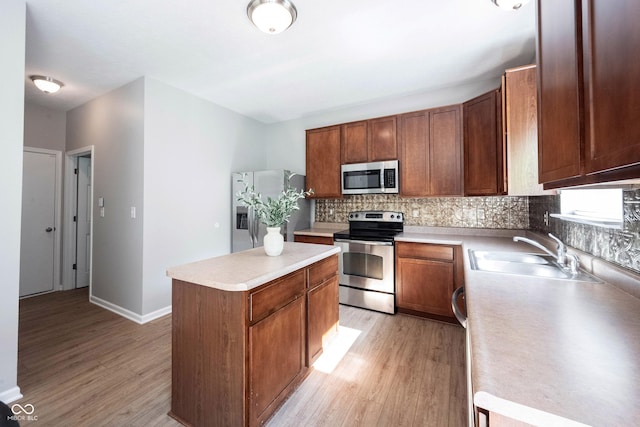13829 Black Canyon Ct, Fishers, IN 46038 - kitchen featuring stainless steel appliances, a center island, light wood-style floors, and tasteful backsplash