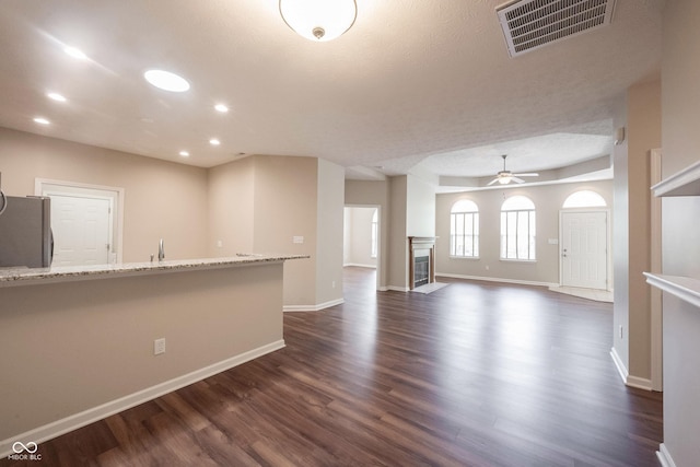 6586 Quail Run, Fishers, IN 46038 - unfurnished living room with dark wood-style floors, a ceiling fan, recessed lighting, and a fireplace with flush hearth