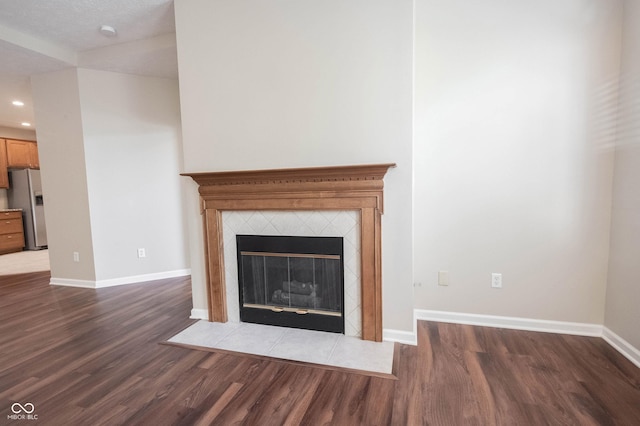 6586 Quail Run, Fishers, IN 46038 - detailed view of stainless steel fridge, wood finished floors, a fireplace, recessed lighting, and a smoke detector