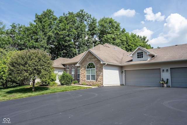 6586 Quail Run, Fishers, IN 46038 - view of front facade with stone siding, an attached garage, asphalt driveway, and a shingled roof