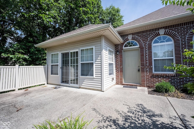 6586 Quail Run, Fishers, IN 46038 - view of exterior entry featuring brick siding, a shingled roof, and a patio area