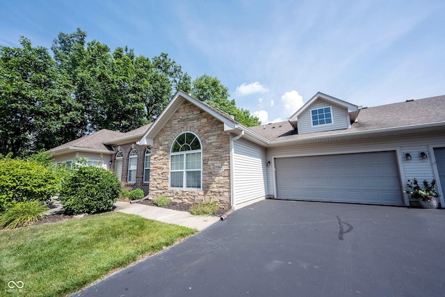 6586 Quail Run, Fishers, IN 46038 - view of front of home featuring asphalt driveway, stone siding, and an attached garage