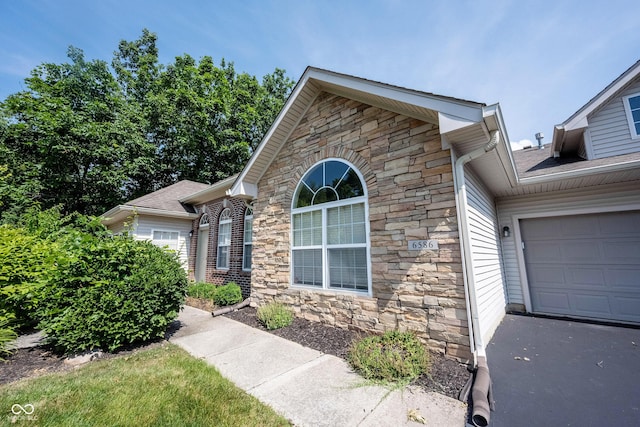 6586 Quail Run, Fishers, IN 46038 - view of front of property with stone siding and a garage