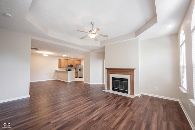 6586 Quail Run, Fishers, IN 46038 - unfurnished living room featuring ceiling fan, dark wood-style floors, a fireplace, recessed lighting, and a raised ceiling