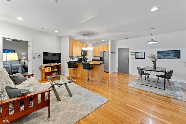 932 N Broadway St Unit 4, Indianapolis, IN 46202 - living room featuring light wood-style flooring, recessed lighting, and a chandelier