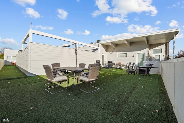 932 N Broadway St Unit 4, Indianapolis, IN 46202 - back of property featuring a fenced backyard and outdoor dining area