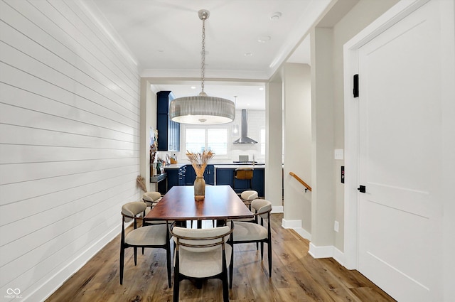 906 Berkhamsted Ln, Carmel, IN 46032 - dining area with wood finished floors, crown molding, and wood walls