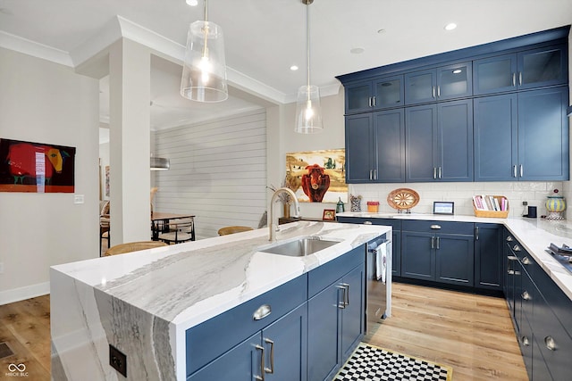 906 Berkhamsted Ln, Carmel, IN 46032 - kitchen featuring crown molding, tasteful backsplash, light stone counters, decorative light fixtures, and light wood-style flooring