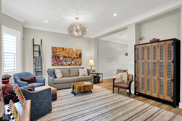 906 Berkhamsted Ln, Carmel, IN 46032 - living room featuring light wood-style floors, a chandelier, recessed lighting, and ornamental molding