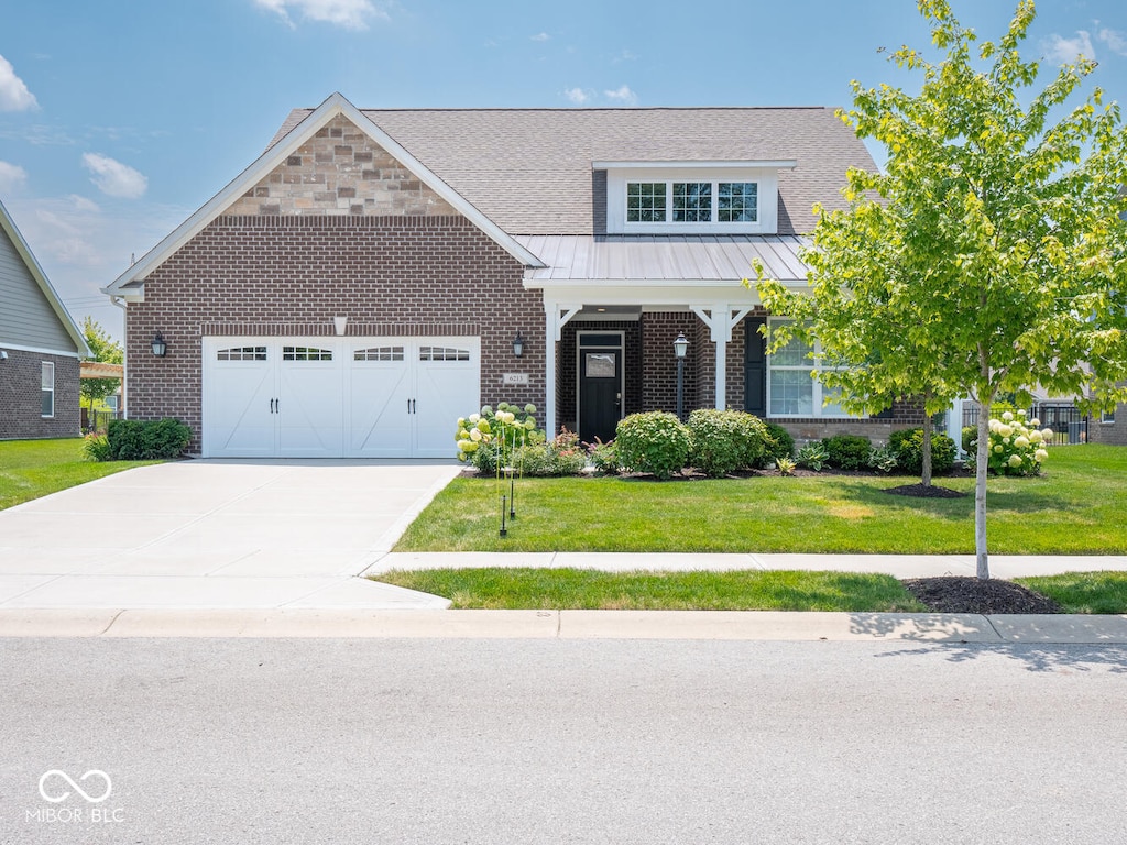 6213 Burgin Dr, Whitestown, IN 46075 - view of front of property with brick siding, a front lawn, concrete driveway, an attached garage, and a standing seam roof