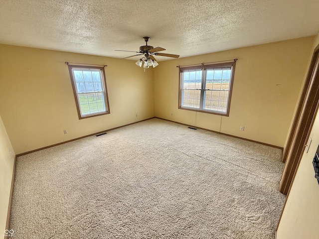 1687 Killion Ave, Seymour, IN 47274 - unfurnished room featuring plenty of natural light, a ceiling fan, light colored carpet, and a textured ceiling