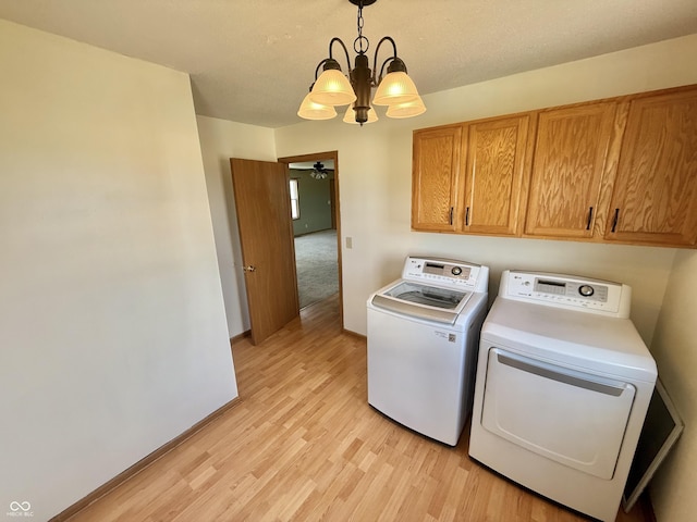 1687 Killion Ave, Seymour, IN 47274 - laundry area with cabinet space, separate washer and dryer, a chandelier, light wood finished floors, and a ceiling fan