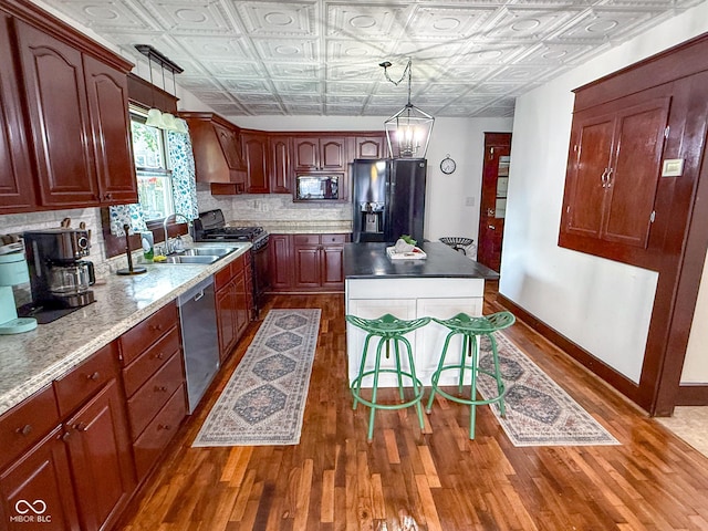 251 N St, Danville, IN 46122 - kitchen with black appliances, an ornate ceiling, wood finished floors, a center island, and decorative backsplash