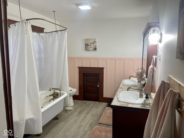 251 N St, Danville, IN 46122 - full bath with double vanity, wood finished floors, wainscoting, and shower / bath combo with shower curtain