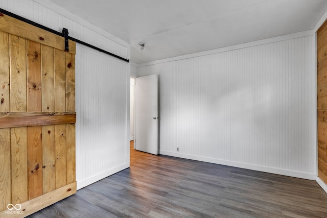 917 W Busby St, Lebanon, IN 46052 - unfurnished bedroom with wood finished floors, a barn door, and wooden walls