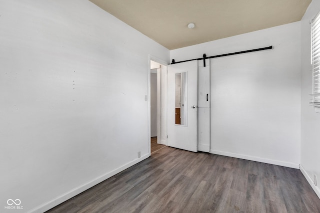 917 W Busby St, Lebanon, IN 46052 - unfurnished bedroom featuring a barn door and wood finished floors