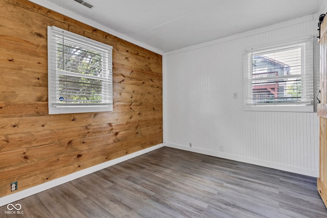 917 W Busby St, Lebanon, IN 46052 - empty room with healthy amount of natural light, wood walls, and wood finished floors